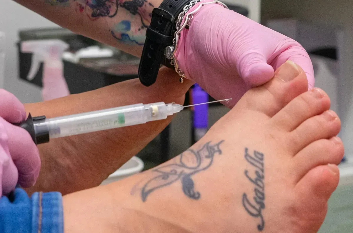 Podiatrist preparing a patient's toe for ingrown toenail treatment