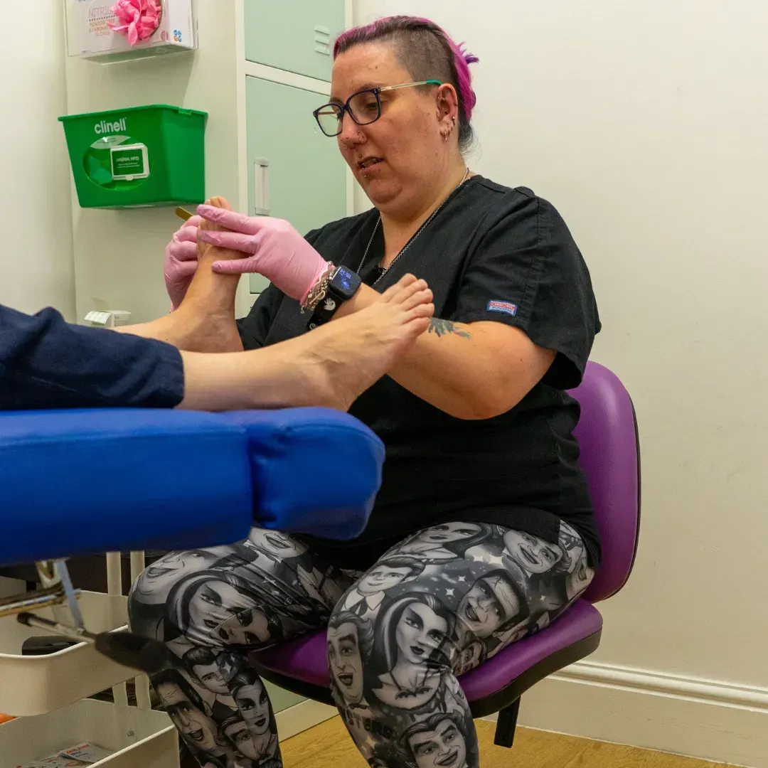 Podiatrist treating a patient's foot in the podiatry chair