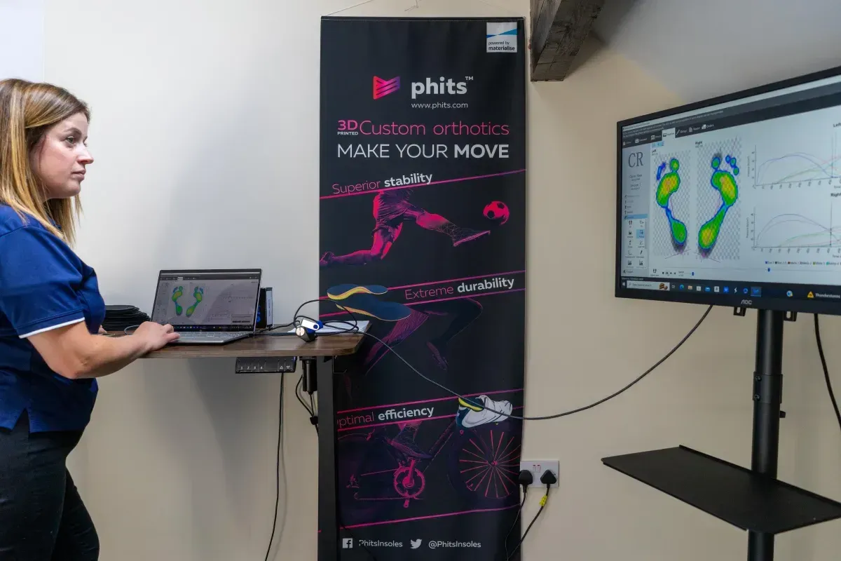 Clinician reviewing a Gaitscan pressure map on a screen